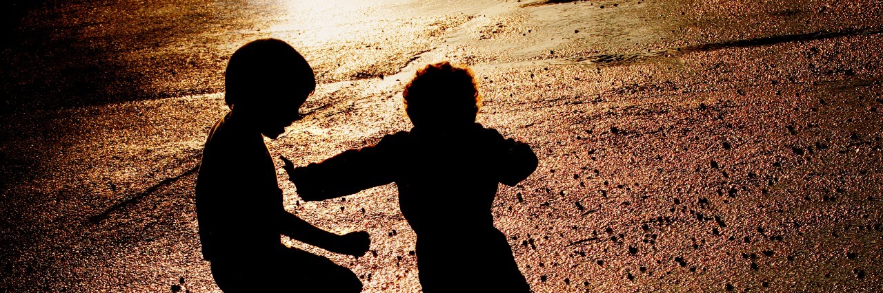 Children pushing in puddle