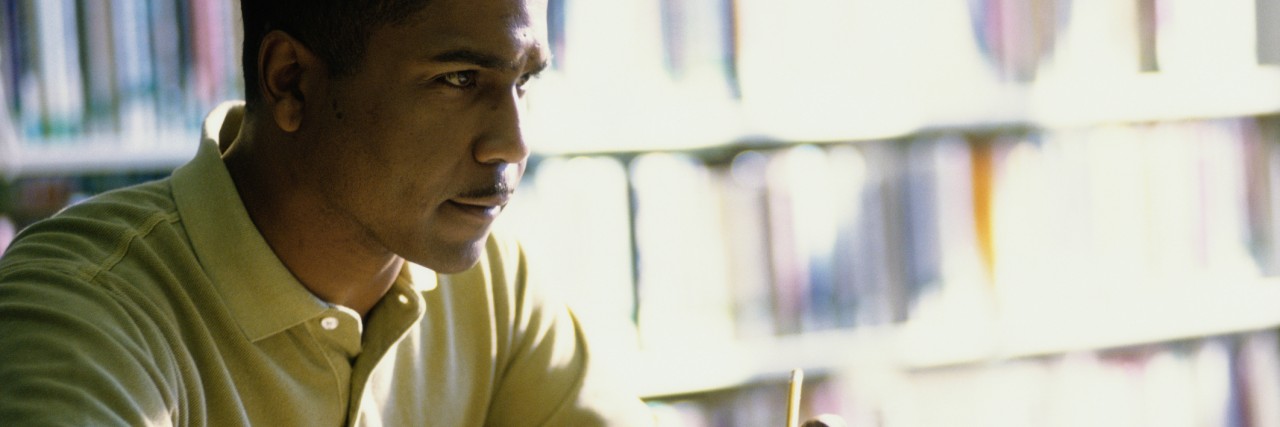 What It's Like to Have a Panic Attack in Class Mid adult man holding a pencil