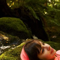Young woman laying in forest