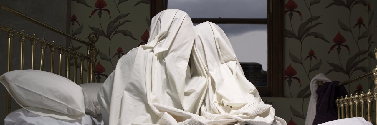 What Dating Is Like as a Man With Mental Illness couple hiding under sheet on bed