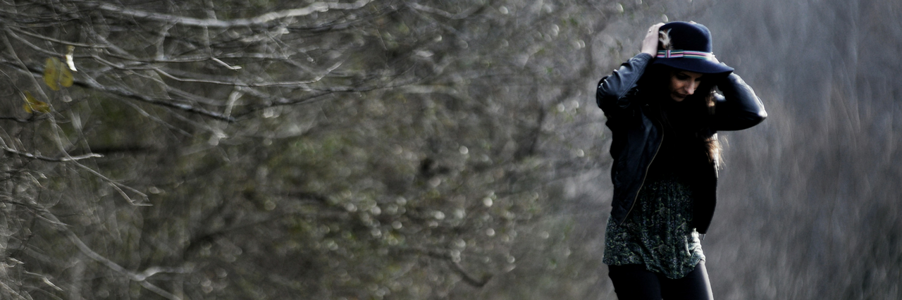 What It Feels Like to Lose Your Sibling Woman wearing hat, walking near a tree in a field