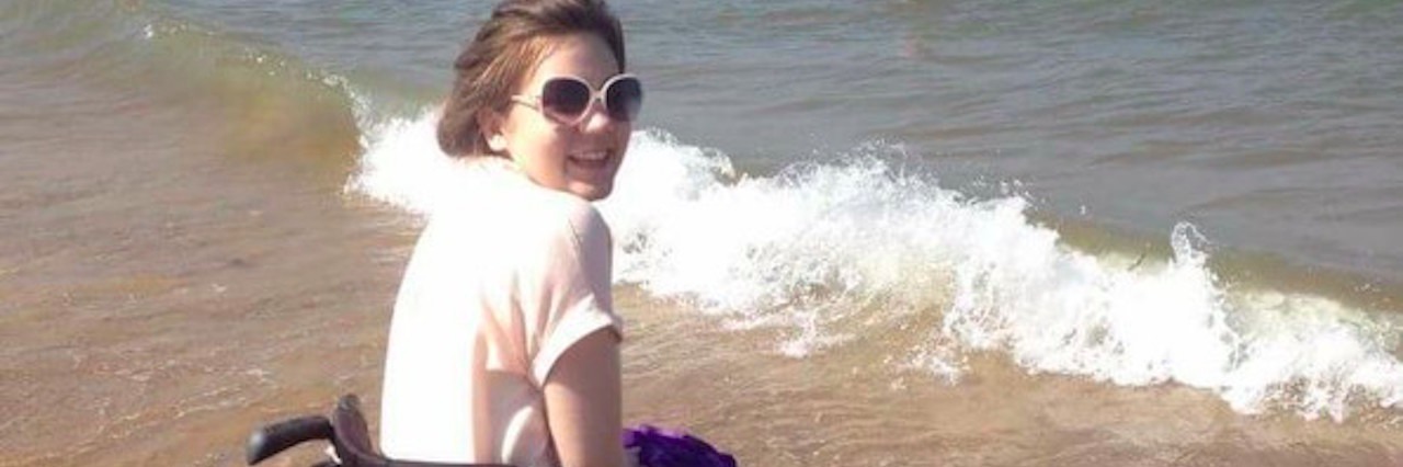 Coping With the New Year With a Serious Illness girl in wheelchair at beach