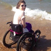 girl in wheelchair at beach
