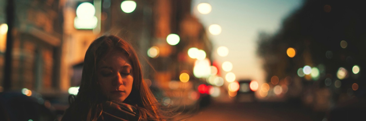 Hidden Signs of Borderline Personality Disorder Woman standing on a street in the dark. text reads: 18 things people don't realize you're doing because of your borderline personality disorder