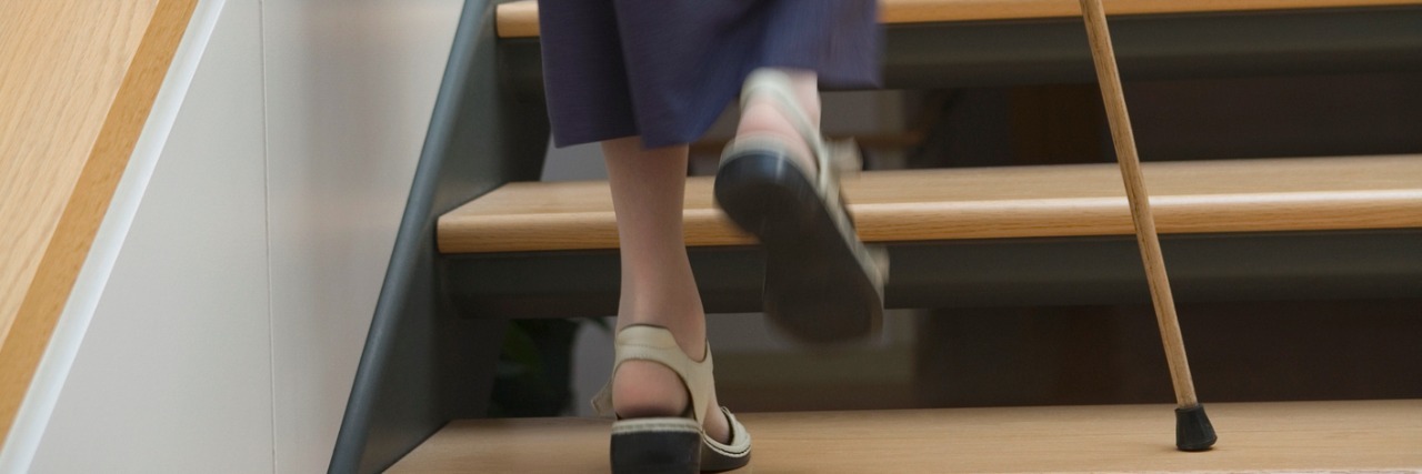 I Used My Cane at Church for the First Time and This Is What Happened woman walking up stairs with cane