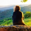 scenic view of woman watching at sunset mountains