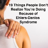 Woman holding her painful shoulder with words 19 things people don't realize you're doing because of ehlers-danlos syndrome