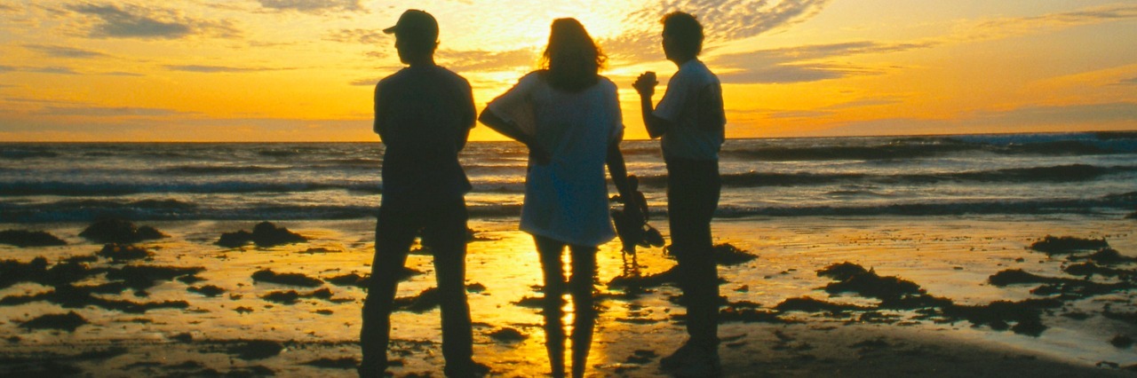 Maintaining Friendships While Living With a Mental Illness Friends watching sunset on beach