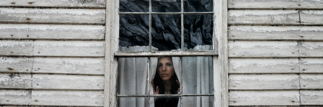 Depression and Chasing Perfection woman looking through a window