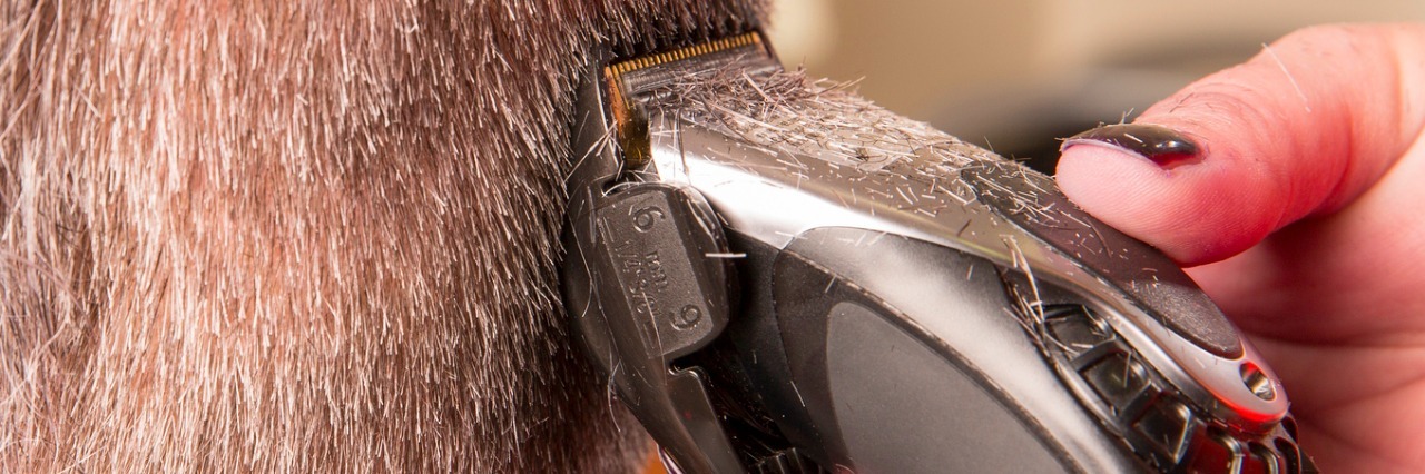 How Shaving My Head Helps Me Cope With Fibromyalgia hand using electric clippers to shave head