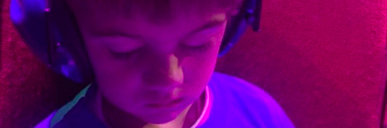 When My Son on the Autism Spectrum Stopped Sleeping Through the Night young boy wearing headphones and sleeping