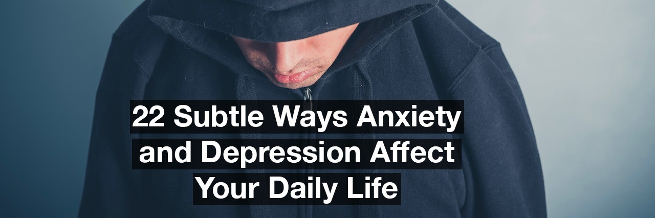 A young man is wearing a hooded top and is looking down. Text reads: 22 subtle ways anxiety and depression affect your daily life.