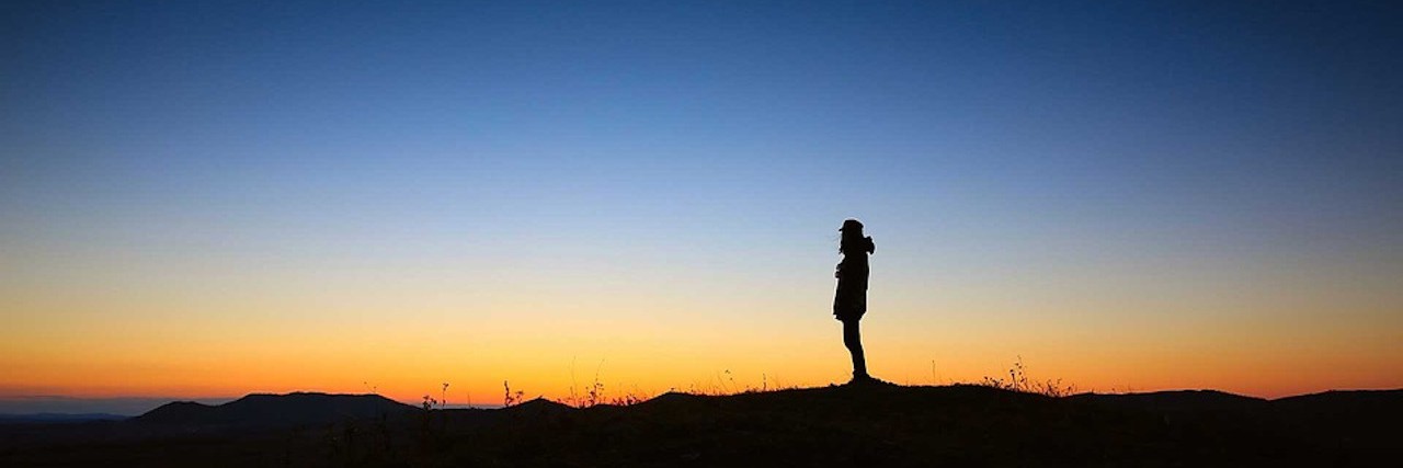 A Q&A to Explain the Darkness of Depression woman at sunset