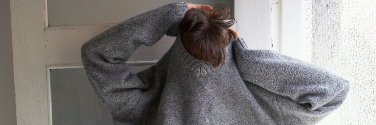 When I Got Stuck in My Sweater While Changing Into a Hospital Gown Woman pulling sweater over head