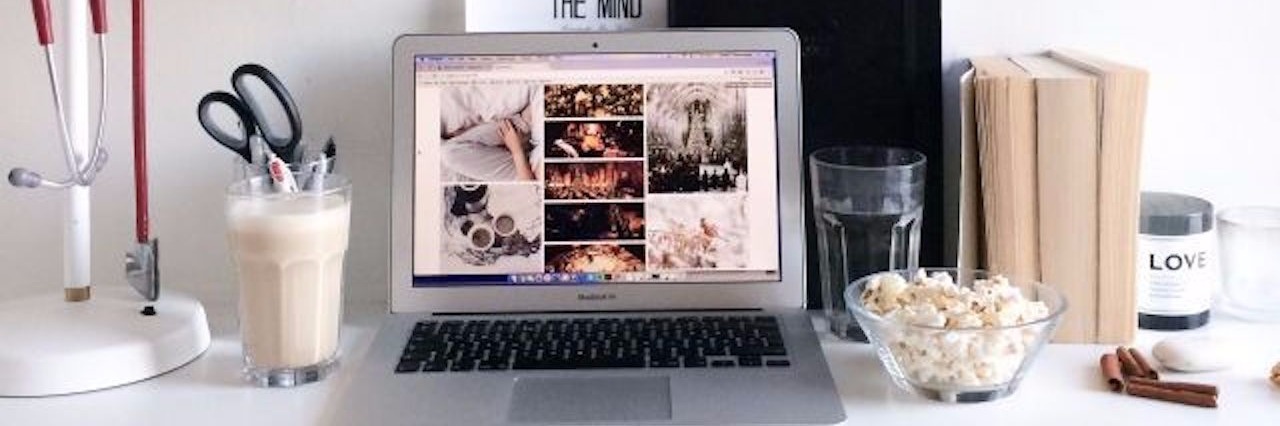 How to Manage College and Chronic Pain desk with laptop, lamp and books