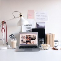 desk with laptop, lamp and books