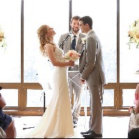 husband and wife standing at the altar getting married and laughing