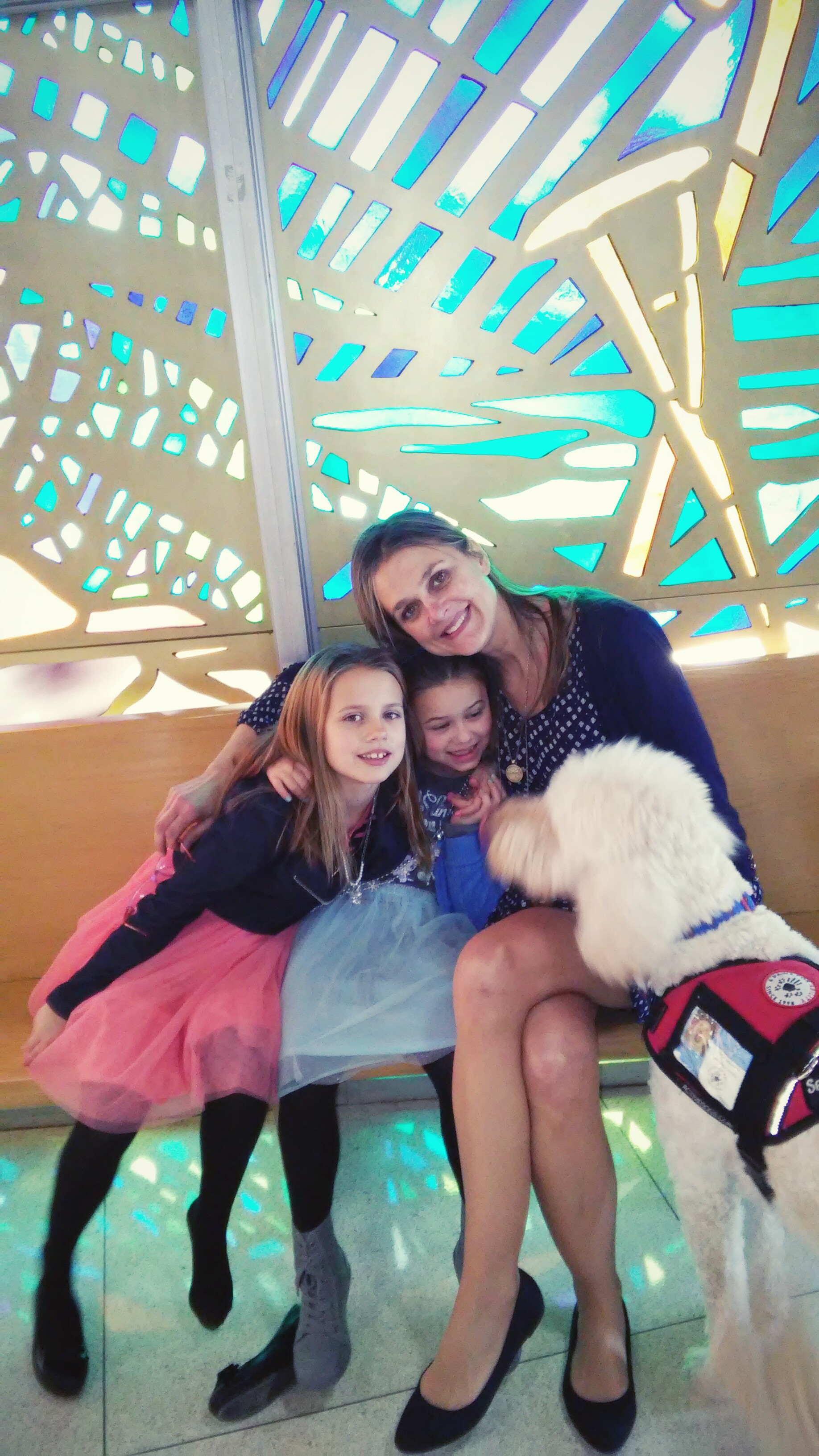 Mom and two girls sitting with service dog