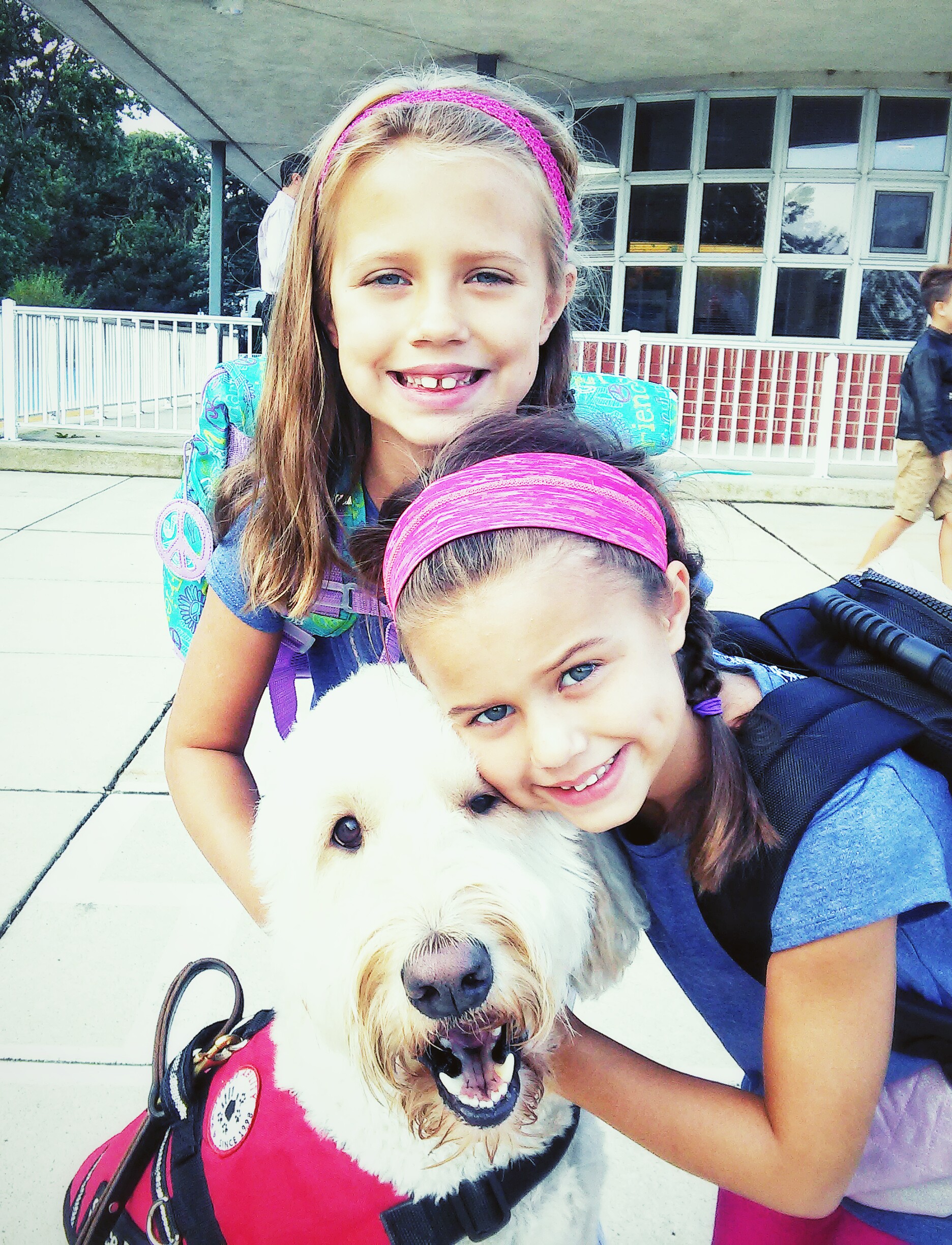 Two girls outside with service dog