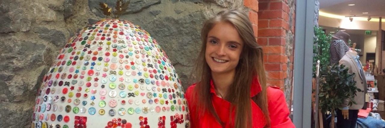 What to Expect When You Are Hospitalized for Anorexia A woman standing next to a sign that says love