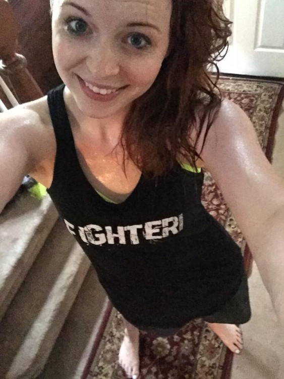 woman wearing tank top that says fighter