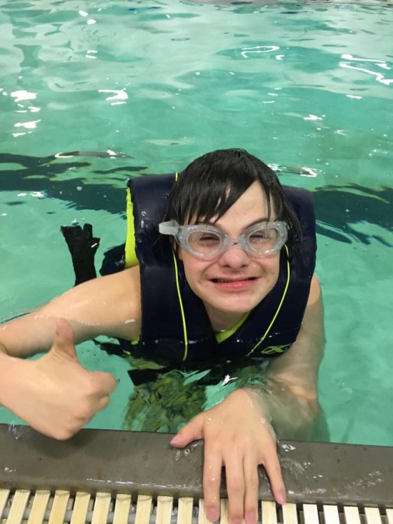 boy with down syndrome in pool