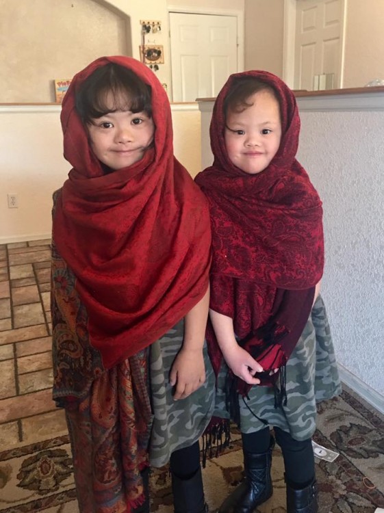 two girls with down syndrome wearing scarves on heads