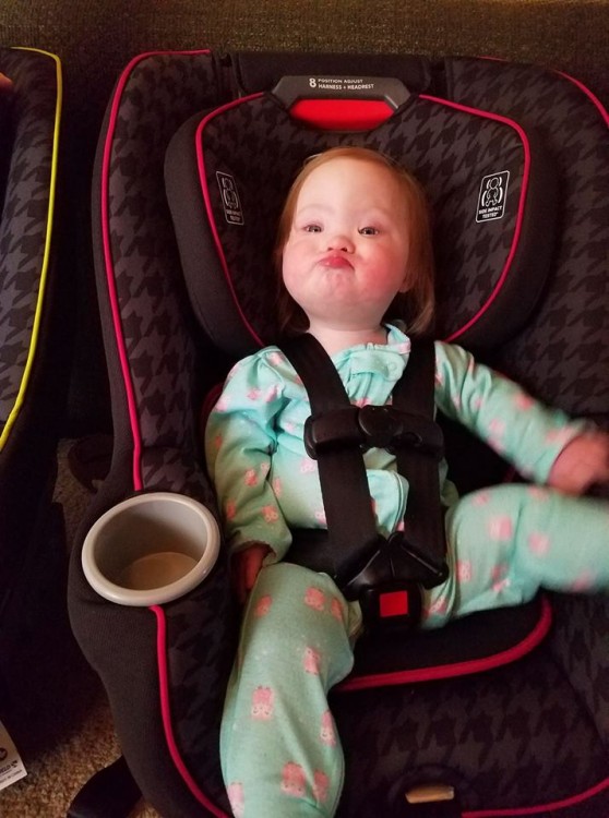 toddler girl with down syndrome in car seat