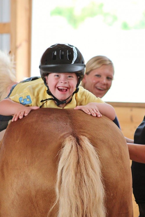 boy with down syndrome riding a horse