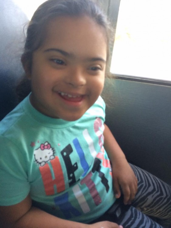 girl with down syndrome sitting in car