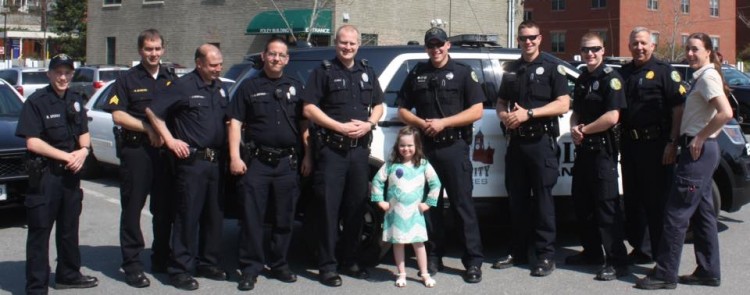 girl with down syndrome standing with police officers