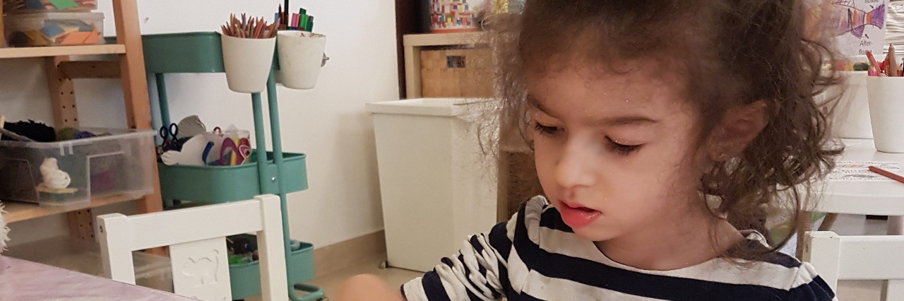 The Challenges of Disability Inclusion in the Arabian Peninsula Tala's daughter finger painting at school..