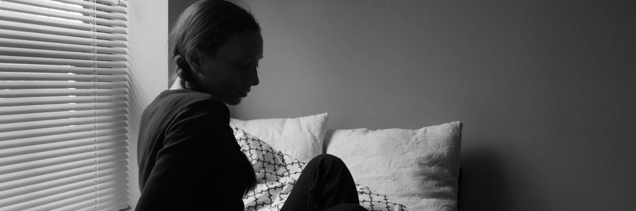 What It Was Like Doing a Photo Shoot About My Illness woman getting out of bed