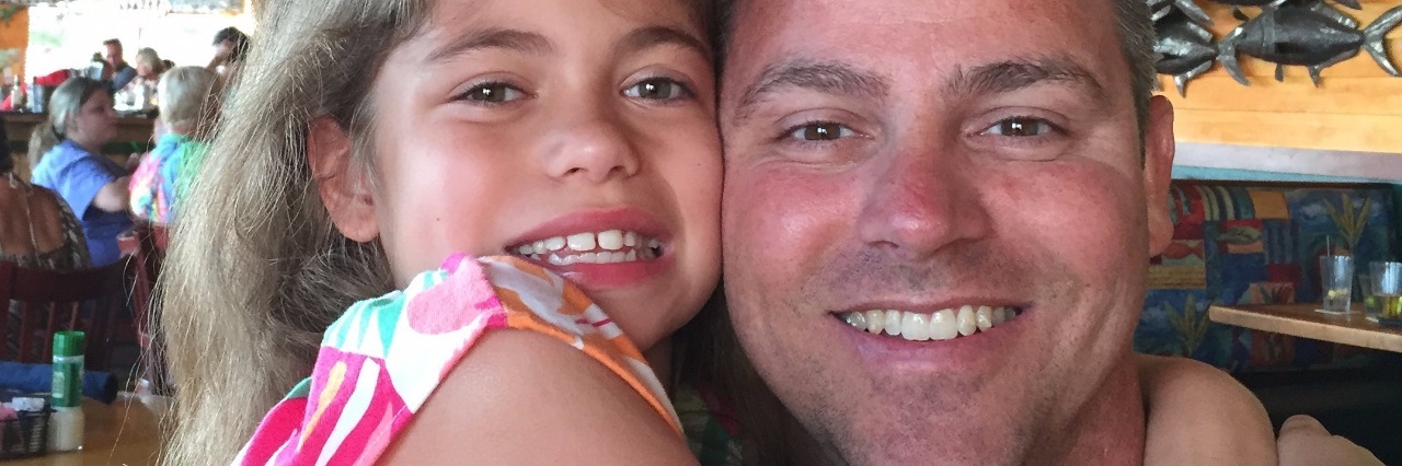 To Dads of Kids With Rare Diseases, Sanfilippo Syndrome dad with little girl and her arms around him