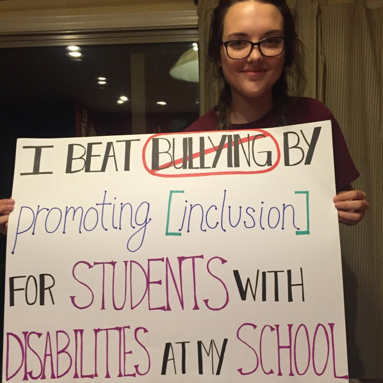 Alexis, 17, holds a sign saying 'I beat bullying by promoting inclusion for students with disabilities at my school.