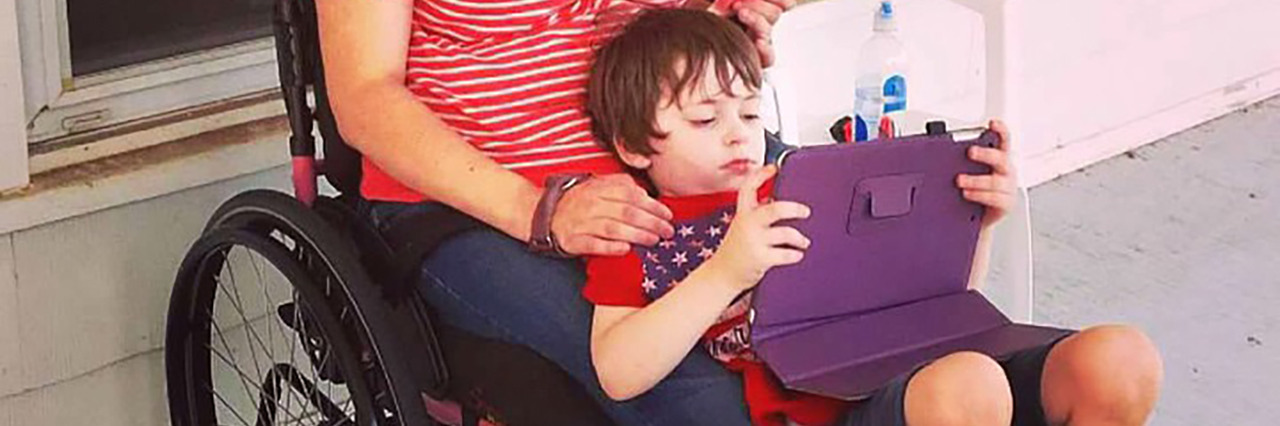 Accepting My Spinal Cord Injury and Using a Wheelchair Paige holding her son.