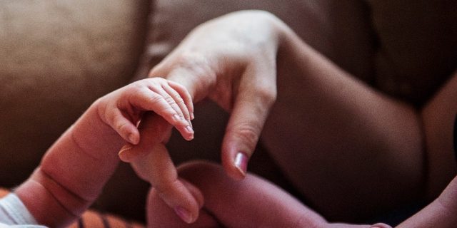 mom and baby's hand