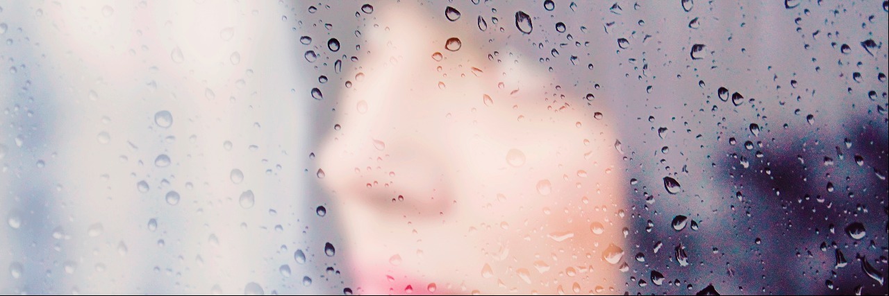 Social Anxiety: Feeling Lonely but Wanting to Be Alone woman behind a rainy window