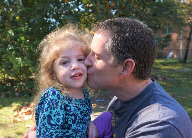 dad kissing his daughter