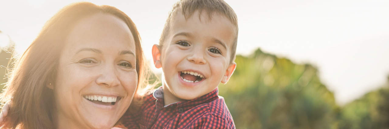 How I Honor My Son on Rare Disease Day Mother holding toddler. They are both smiling.