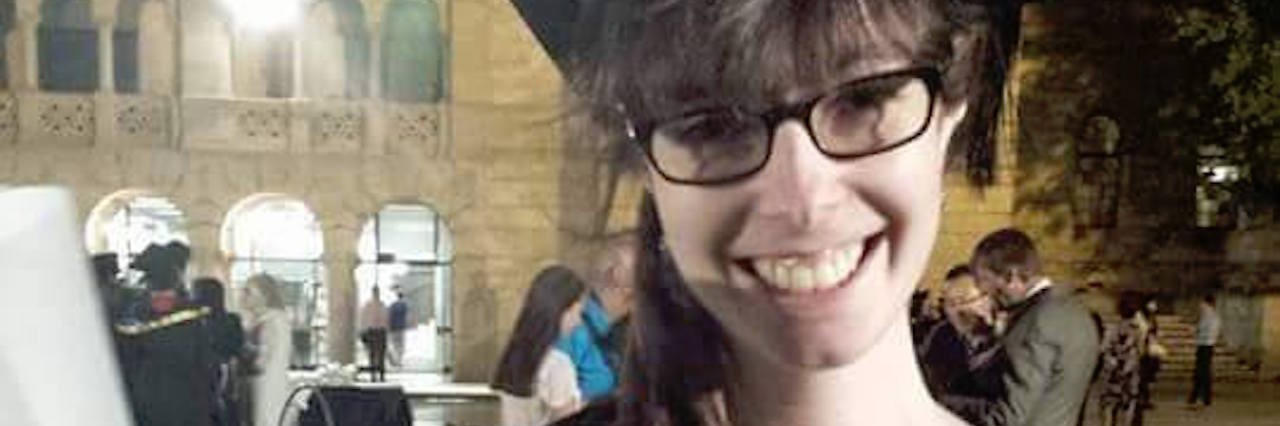 Grieving After My Crohn's Disease Diagnosis woman wearing cap and gown at her college graduation