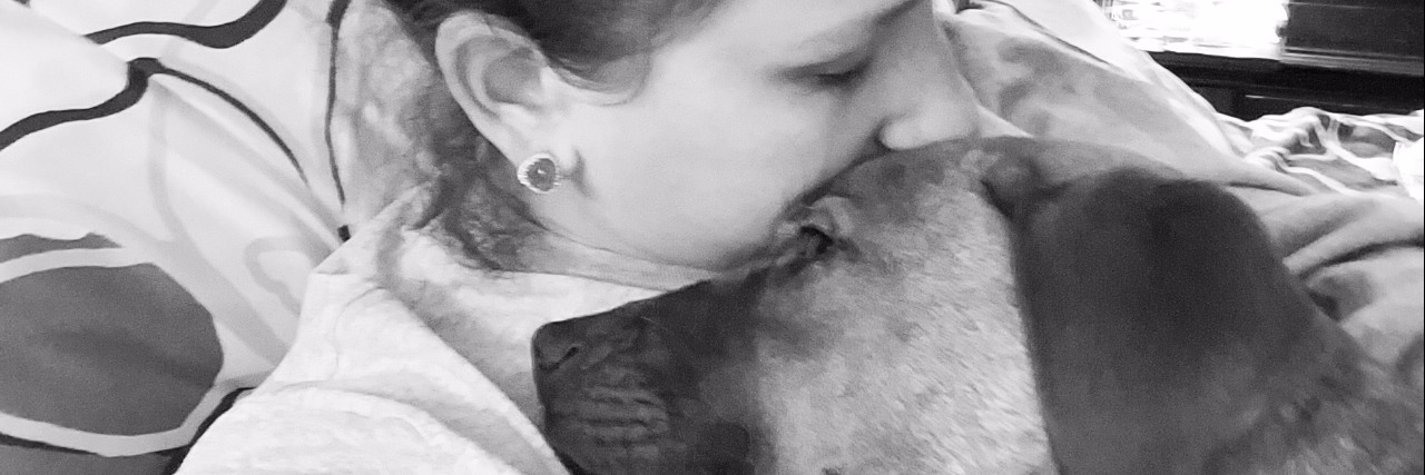 Why Rescuing a Puppy Helped With My Anxiety girl cuddling with puppy dog black and white