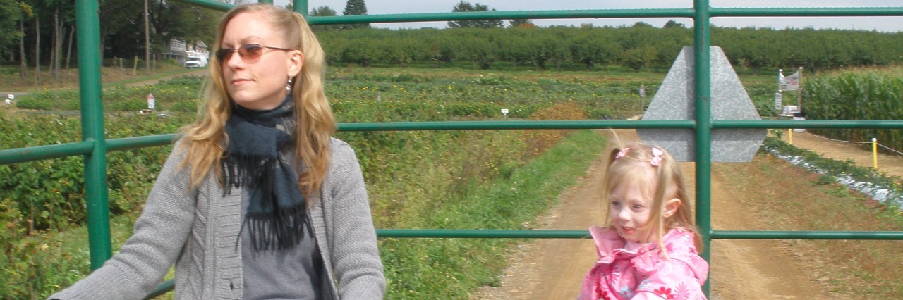 Things That Help Me While I'm Waiting for News on My Medical Condition Image is a mother and daughter sitting on hay inside a truck and going on a hay ride.
