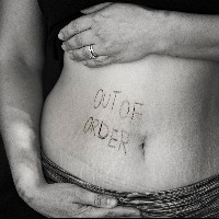 woman's stomach with out of order written on it