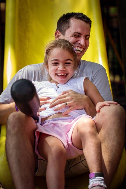dad sliding down slide with daughter