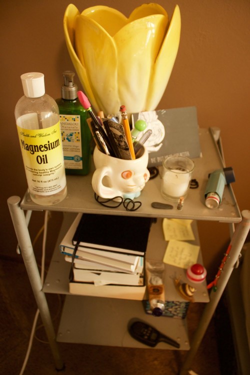 Emma Jones' nightstand featuring magnesium oil and a tulip lamp.