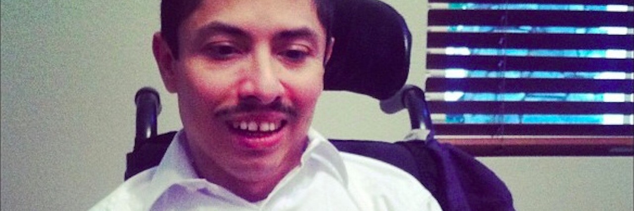 How My Brother-In-Law Was Diagnosed With Pelizaeus-Merzbacher Disease man sitting at table with cake