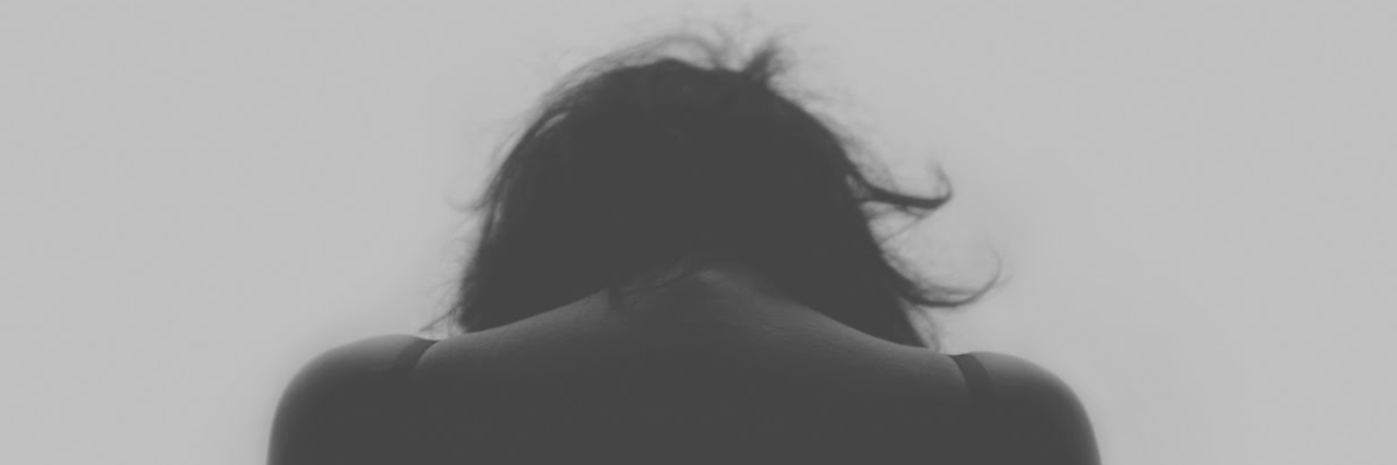 When Borderline Personality Disorder Makes You 'Addicted' to People Woman looking down back facing camera black and white