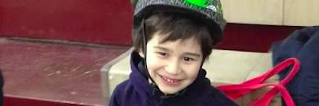 Mom Shares How She Advocates Locally for Disability Community Boy wearing hoodie and dinosaur-themed bike helmet