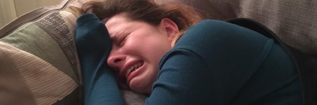 Sophie Eliza's Facebook Video Show Bipolar Disorder, Psychotic Episode Photo of a woman on the couch criyng